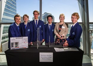 A group of five students with their teacher from North Beaches Secondary College stood behind the display table as the winners of the 2021 winners of the Metro Minds Steam challenge. 