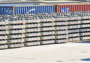 Stacks of pre-cast concreate are lined up in front of several shipping containers at Sydney Metro Trains Facility South Yard.