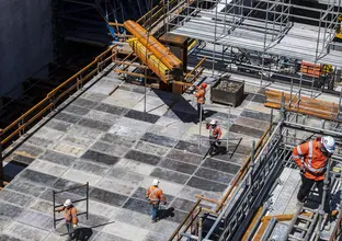 A view from above looking down at construction workers in the Waterloo station box site.