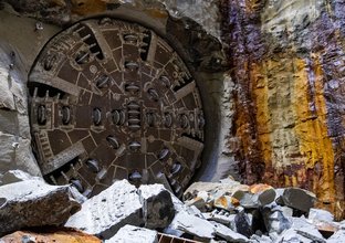 An on the ground view of Tunnel Boring Machine (TBM) Mabel breaking through at Blues Point tunnel access site on the edge of Sydney Harbour.