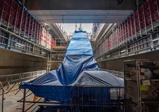 New escalators covered in blue tarp are ready for installation on B3 level (concourse) down to the platform level at Waterloo station