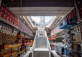 Ground level view of construction workers working on Sydney Metro's Waterloo Station platform level.