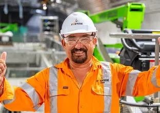 Construction worker giving two thumbs up at inside the cavern at Sydney Metro's Victoria Cross Station. 