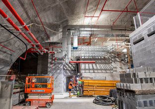 An on the ground view of construction site inside the south cavern at Sydney Metro's Victoria Cross Station. 