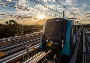 Sydney Metro train on the tracks arriving at Sydney Metro's Kellyville Station.