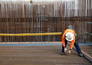 Construction worker installing metal rods at Sydney Metro's Crows Nest Station.