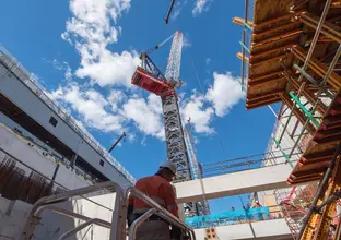 A ground up view of construction work and crane tower at Sydney Metro's Crows Nest Station.