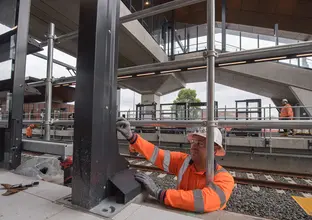 Construction workers installing platform screen doors at Sydney Metro's Sydenham Station.