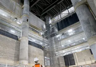 A ground up view of construction worker viewing the construction of the atrium at Sydney Metro's Martin Place Station.