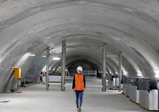 Construction worker walking through the underground caverns at Sydney Metro's Martin Place Station.