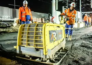 Construction worker using a concrete levelling machine at Sydney Metro's Chatswood Station