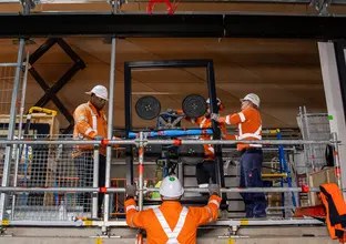 Construction workers installing platform screen doors at Central Station. 