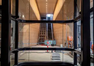 Central Station escalators as viewed from inside a lift through glass windows