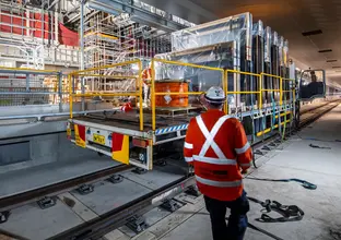 HyRail truck carrying platform screen doors through an underground tunnel