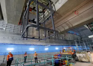 Construction workers supervising steel structure lift inside Barangaroo Station box