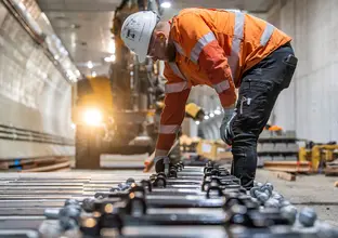 Construction worker laying final rail tracks