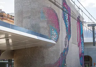 Colourful aboriginal artwork covers the brick ventilation buildings at Central Station.