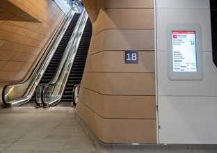 Wide shot of escalators at Central Station's new underground concourse to platform 18