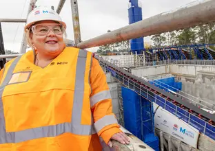 Catherine White standing in a Sydney Metro construction site wearing safety gears