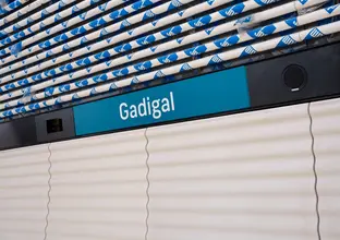 Signage of Gadigal station  in white letters on blue background, which is Sydney Metro's brand color