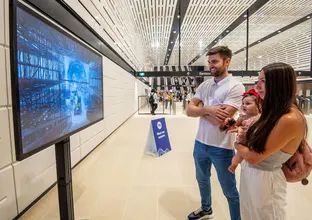 Couple looking at a screen showing construction