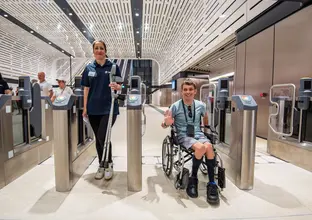 Boy in a wheelchair going through the opal gates