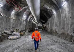 Man walking through tunnel in Hi Vis gear