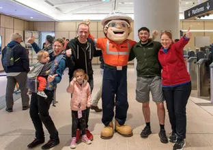 Metro Mascot with a group of people