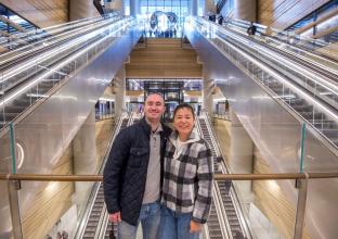 Couple in front of the various escalators