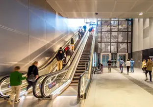 Image of escalators and lifts with members of the going up and down