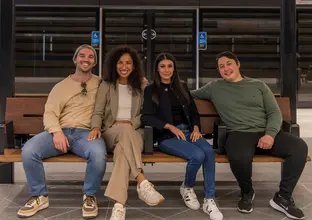 Group of 4 sitting at a bench on the platform