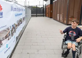 A member of public in a wheelchair is attending Sydenham Community Open Day 