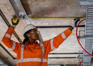 A woman worker working at the construction site wearing safety gears