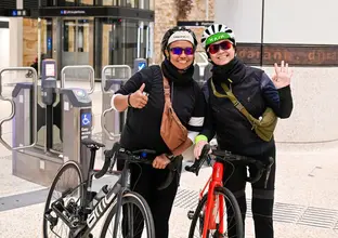 two people with a bike at the metro station