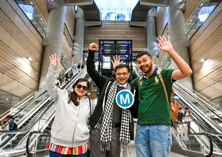 people holding the M logo at a metro station