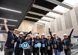 Sydney Metro employees at the City stations opening holding the M logo