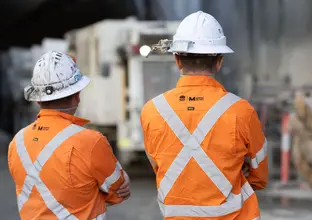 two construction worker looking at the truck