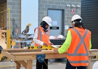 two women are working at the construction site workshop