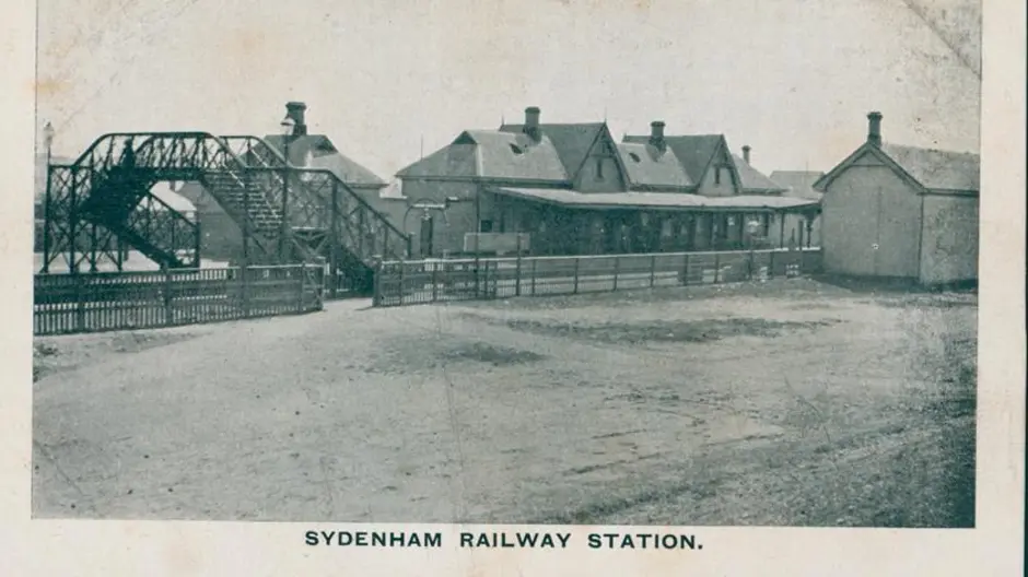 An old black and white photo of Sydenham Railway Station in circa 1910. The title 'Sydenham Railway Station' is at the bottom of the image.