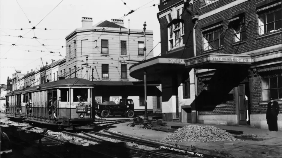 Old black and white photo of a tram going down Regent Street in Sydney.