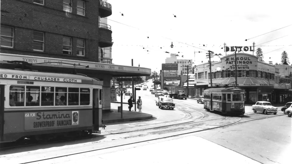 Black and white photo of trams and cars travelling on the Pacific Highway, North Sydney