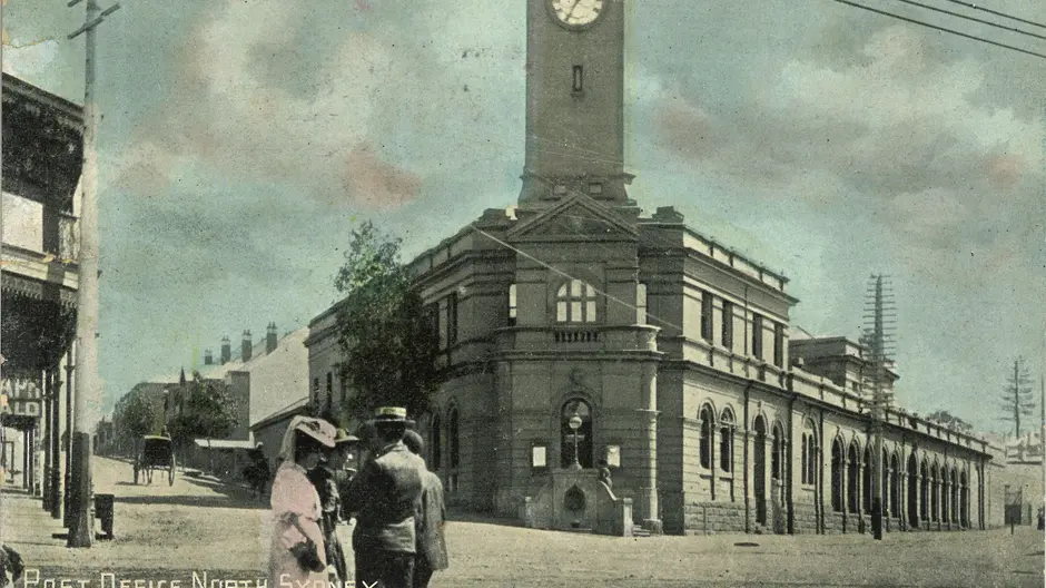 A colourised photo of people standing outside of the North Sydney Post Office, circa 1900s.