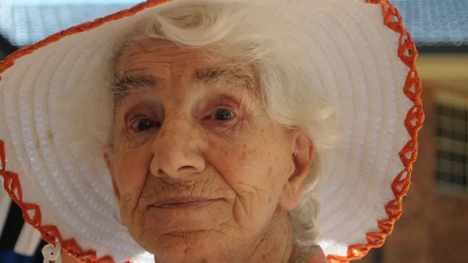 Dorothy Buckland Fuller wearing a white hat with orange hem work