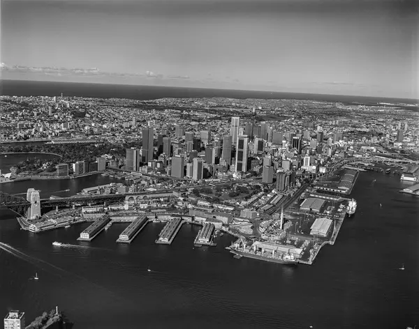 Black and white photograph of an aerial view of Sydney Harbour in 1980s.