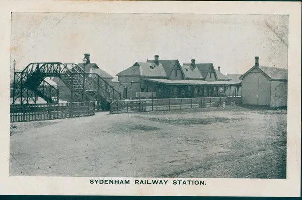 An old black and white photo of Sydenham Railway Station in circa 1910. The title 'Sydenham Railway Station' is at the bottom of the image.