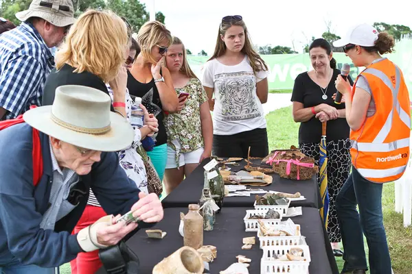 Community members looking at artefacts