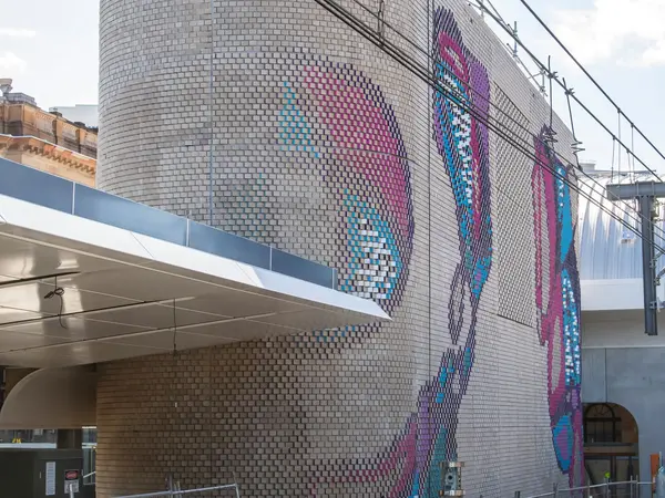 Colourful aboriginal artwork covers the brick ventilation buildings at Central Station.