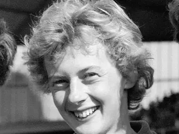 A young Betty Cuthbert with short hair, smiling