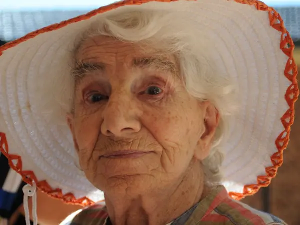 Dorothy Buckland Fuller wearing a white hat with orange hem work