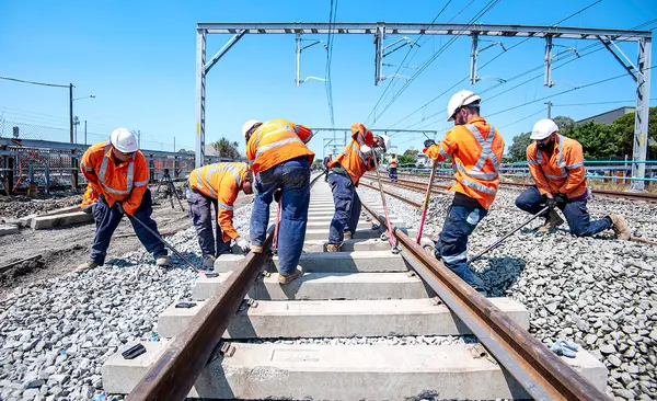 Construction workers laying track.